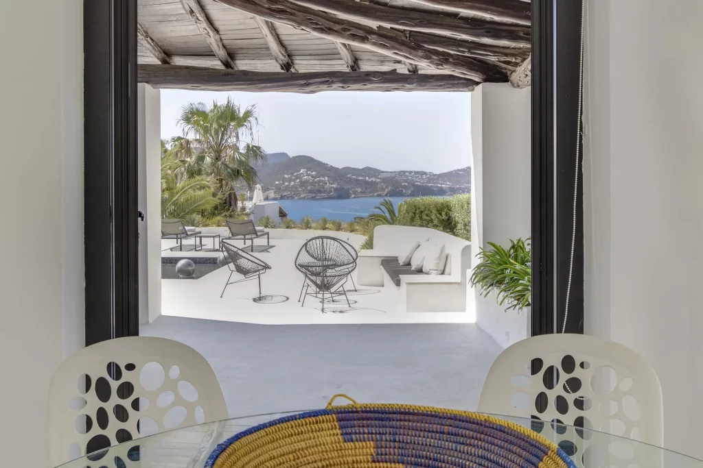 Sea-breeze dining terrace under pergola at Can Sarmiento