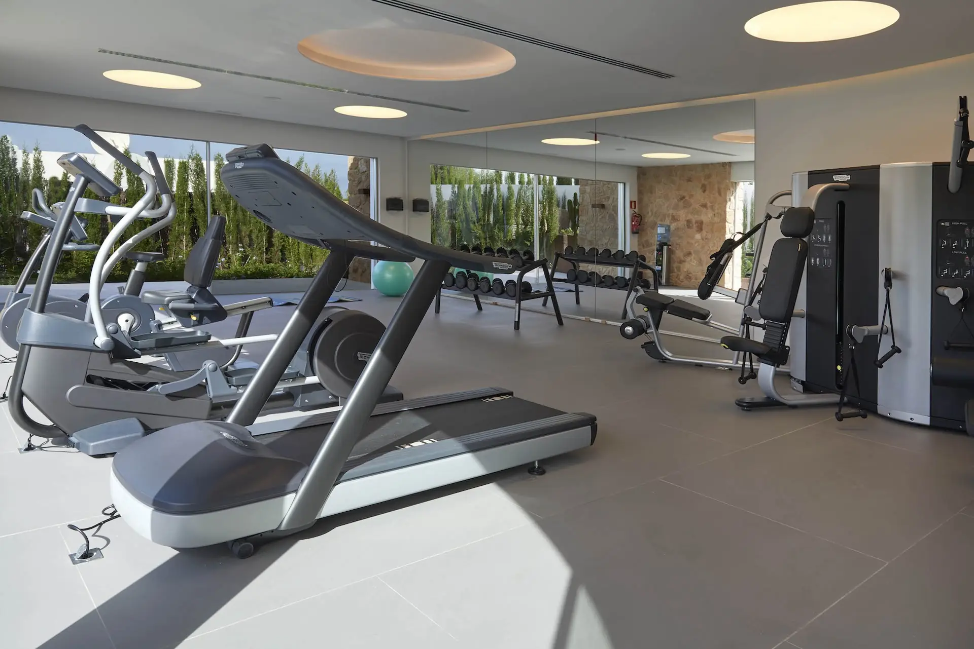 Community gym with cardio and strength machines in Cala Conta